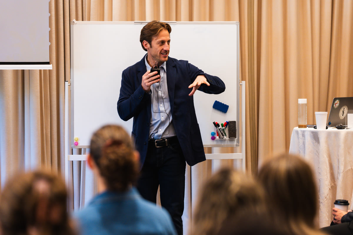 Austin at the whiteboard teaching the room