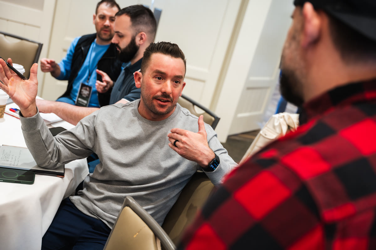 An attendee gesturing during a group discussion