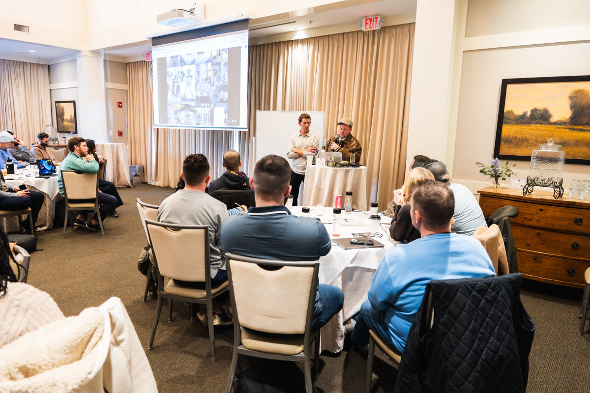 Growth Summit conference room with attendees at round tables