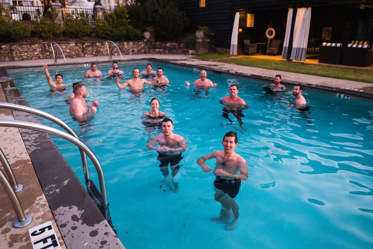 Growth Summit attendees standing together in a pool