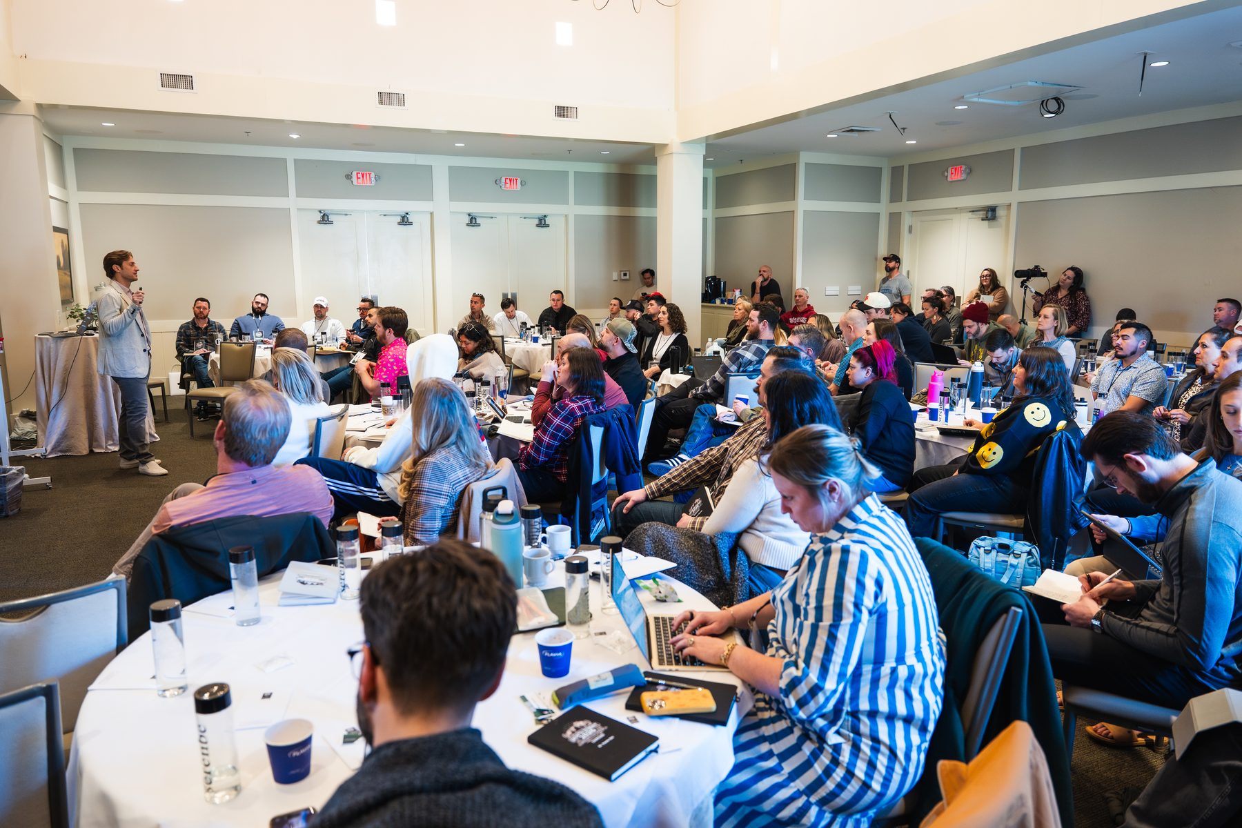 Growth Summit attendees working in a full room